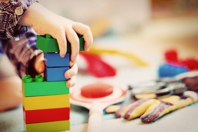 child stacking blocks