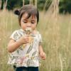 child sniffing daisy